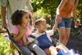 Family With Children Pushed In Barrow By Parents Working In Vegetable Garden Or Allotment Royalty Free Stock Photo