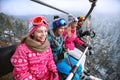 Family in ski lift going to ski terrain Royalty Free Stock Photo