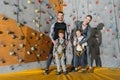 Family with children standing together near climbing walls at gym and looking Royalty Free Stock Photo