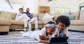 Family, children and tablet on floor watching cartoons, parents and living room couch. Screen time, relaxing and Royalty Free Stock Photo