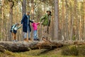 Family with children walking on fallen tree in forest Royalty Free Stock Photo