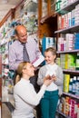 Family choosing items in pharmacy Royalty Free Stock Photo