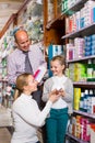 Family choosing items in pharmacy Royalty Free Stock Photo