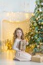 Family on Christmas eve at fireplace. Kids opening Xmas presents. Children under Christmas tree with gift boxes. Decorated living Royalty Free Stock Photo