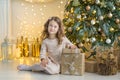 Family on Christmas eve at fireplace. Kids opening Xmas presents. Children under Christmas tree with gift boxes. Decorated living Royalty Free Stock Photo