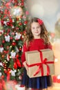 Family on Christmas eve at fireplace. Kids opening Xmas presents. Children under Christmas tree with gift boxes. Decorated living Royalty Free Stock Photo