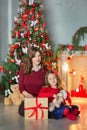 Family on Christmas eve at fireplace. Kids opening Xmas presents. Children under Christmas tree with gift boxes. Decorated living Royalty Free Stock Photo