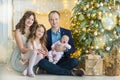 Family on Christmas eve at fireplace. Kids opening Xmas presents. Children under Christmas tree with gift boxes. Decorated living Royalty Free Stock Photo