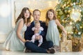 Family on Christmas eve at fireplace. Kids opening Xmas presents. Children under Christmas tree with gift boxes. Decorated living Royalty Free Stock Photo