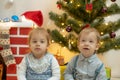 Family on Christmas eve at fireplace. Mother and little kids opening Xmas presents. Children with gift boxes. Living Royalty Free Stock Photo