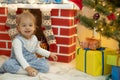 Family on Christmas eve at fireplace. Mother and little kids opening Xmas presents. Children with gift boxes. Living Royalty Free Stock Photo