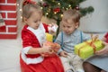 Family on Christmas eve at fireplace. Mother and little kids opening Xmas presents. Children with gift boxes. Living Royalty Free Stock Photo