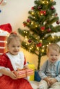 Family on Christmas eve at fireplace. Mother and little kids opening Xmas presents. Children with gift boxes. Living Royalty Free Stock Photo