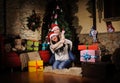 Family on Christmas eve. Mother and daughter and dog with Xmas presents. Family with gift boxes. Living room with decorated tree. Royalty Free Stock Photo