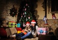 Family on Christmas eve. Mother and daughter with Xmas presents. Family with gift boxes. Living room with decorated tree. Cozy Royalty Free Stock Photo