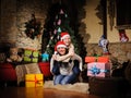 Family on Christmas eve. Mother and daughter with Xmas presents. Family with gift boxes. Living room with decorated tree. Cozy Royalty Free Stock Photo