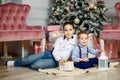 Family on Christmas eve near christmas tree. Holiday gatherings Royalty Free Stock Photo