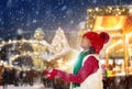 Family at Christmas fair in snow. Xmas market Royalty Free Stock Photo