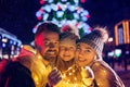 Family, christmas, holidays, season and people concept - happy family over city background and snow