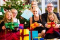 Family with Christmas presents under tree Royalty Free Stock Photo