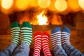 Family in Christmas socks near fireplace