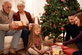 Family, christmas tree and gifts with kids, parents and grandparents together with giving in living room. Home, happy Royalty Free Stock Photo