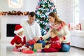 Family at Christmas tree. Parents and kids on Xmas Royalty Free Stock Photo