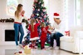 Family at Christmas tree. Parents and kids on Xmas Royalty Free Stock Photo