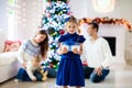 Family at Christmas tree. Parents and kids on Xmas Royalty Free Stock Photo