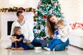 Family at Christmas tree. Parents and kids on Xmas Royalty Free Stock Photo