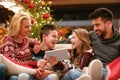 family, Christmas, x-mas, technology and people concept - watching funny video on digital tablet.