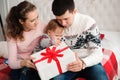 Family, christmas, x-mas, winter, happiness and people concept - happy family opening gift box. Royalty Free Stock Photo