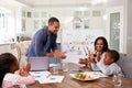 Family clapping at a domestic meeting in their kitchen