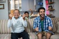 Family clenching fist while watching soccer match