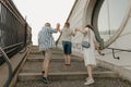 A family is climbing the stairs of the palace in an old European town.