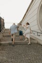 A family is climbing the stairs of the palace in an old European town.