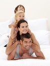 Family climbing on top of each other in bed Royalty Free Stock Photo