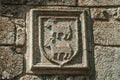 Family coat of arms carved on stone in a medieval chapel