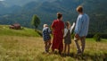 Family coming down hill enjoying summer. Couple walking with kids on nature. Royalty Free Stock Photo