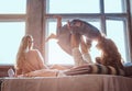 Mom, dad and daughter in bed. Father playing with adorable daughter in bedroom.