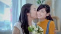 Family concept, mother and daughter are showing love each other by kissing. South East Asian families