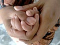 Family concept protection and happiness, the baby`s hand is held by the mother