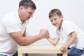 Family Concepts. Father is Having Funny Armwrestling Tournament Royalty Free Stock Photo