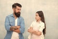 Family conflict. Bearded hipster man and child girl. Confrontation concept. Frowning man and serious daughter. Solving