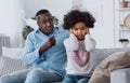 Family conflict caused by coronavirus isolation. Angry granddad and his granddaughter closing her ears indoors Royalty Free Stock Photo