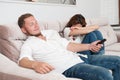 Family conflict issue happy man and upset woman cant share remote control for tv set at home