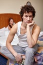 Family conflict. Young couple quarrels in bedroom at home.  Selective focus on man Royalty Free Stock Photo