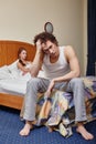 Family conflict. Young couple quarrels in bedroom at home.  Selective focus on woman Royalty Free Stock Photo