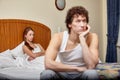 Family conflict. Young couple quarrels in bedroom at home.  Selective focus on woman Royalty Free Stock Photo