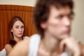 Family conflict. Young couple quarrels in bedroom at home.  Selective focus on woman Royalty Free Stock Photo